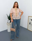 Lace blouse made from cotton and nylon with delicate design and fine lace, image of elegant model.