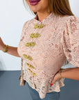 Lace blouse made from cotton and nylon, with delicate design and sheer details, suitable for stylish everyday appearance.