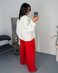 Wide satin trousers with a composition of 97% polyester and 3% elastane, shown on a model, white background.