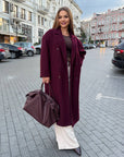 Long faux-cashmere coat with polyester, viscose and wool, shown on a model, in a classic style and neutral colour.