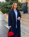 Long faux-cashmere coat with polyester, viscose and wool, black, model with hood and elegant design.