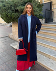 Long faux-cashmere coat with polyester, viscose and wool, model with elegant design and long sleeves.