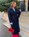 Long faux cashmere coat with polyester, viscose and wool, shown in the image, with classic cut and stylish design.