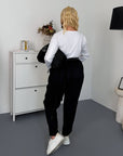 Corduroy trousers from an Italian brand, with viscose, cotton and elastane, lying against a background.