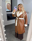 Long faux leather coat, 100% polyamide, with a modern design and classic cut, ideal for winter style.
