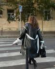 Long faux leather coat, 100% polyamide, with long sleeves and a classic cut, suitable for autumn and winter.