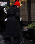 Long mixed-fabric coat in polyester and spandex, black, shown on a model, with a hood and long sleeves.