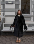 Long mixed-fabric coat in polyester and spandex, worn by a model as a stylish winter outfit.