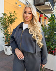 Velour hooded set in polyester and spandex, shown on a model, in grey, comfortable and stylish for everyday wear.