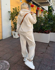 Velour hooded set in polyester and spandex, with a hood and long sleeves, in a neutral colour.