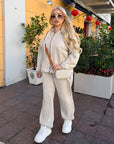 Velour hooded set in polyester and spandex, a fashionable sporty ensemble in beige.
