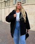 Short faux fur coat in polyester and acrylic, shown on a model, in beige with a fluffy texture.