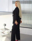 Elegant embellished dress made of polyester, viscose and spandex, shown on a model in the image.