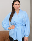 Stylish V-neck blouse in viscose and polyester, shown on a model, in a light colour.