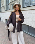 Cropped cardigan with a belt made from polyester and viscose, model with elegant design and focus on the waist, in the photo.
