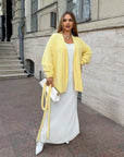 Cropped cardigan with a belt made from cotton and polyester, image of stylish women's cardigan with cord for the bust.