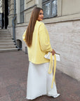 Cropped cardigan with a belt made from cotton and polyester, model in white, with light flared cut and stylish design.