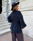 Cropped cardigan with a belt made from polyester and viscose, image of a model, worn stylish and elegant design.
