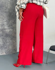 Women's wide-leg trousers made from polyester, viscose and spandex, shown on a model, in a light colour.