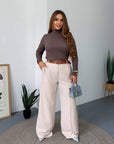 Women's wide-leg trousers made from polyester, viscose and spandex, shown on a model in the image.