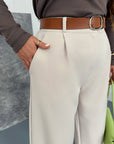 Women's wide-leg trousers made from polyester, viscose and spandex, white, model for everyday wear.