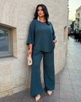 Loose-fitting set with rhinestones, polyester, viscose and lycra, placed on smooth surface.