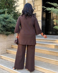 Loose-fitting set with rhinestones, made from polyester, viscose and lycra, shown on a model.