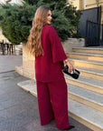 Loose-fitting set with rhinestones, made from polyester, viscose and lycra, shown on a model.