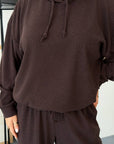 Soft ribbed-knit set in gentle colours, composition of polyester, viscose and elastane, for comfort and style.