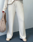 Soft ribbed knitted set made from polyester, viscose and elastane, shown on a model, suitable for everyday wear.